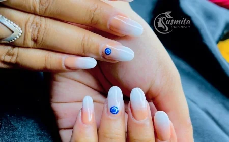 Elegant Nude Ombre Nails with Blue Evil Eye Design – Minimalist Nail Art Look